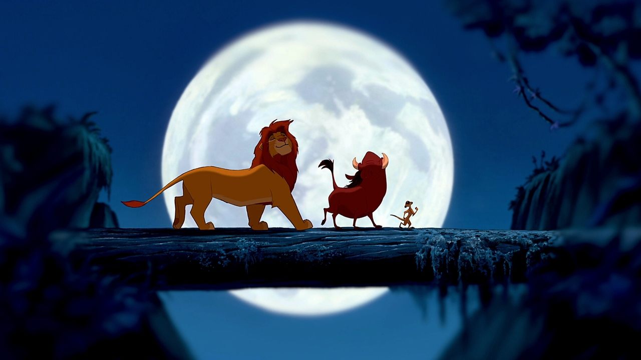Adult Simba walking on a moonlit log bridge with Pumbaa and Timon, full moon backlighting the silhouettes.
